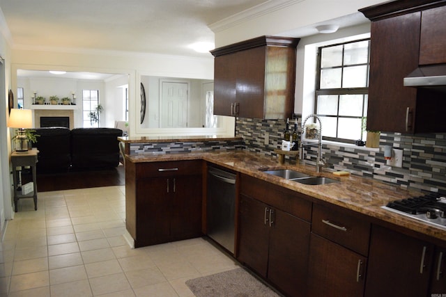 kitchen featuring dark stone counters, crown molding, sink, tasteful backsplash, and stainless steel appliances