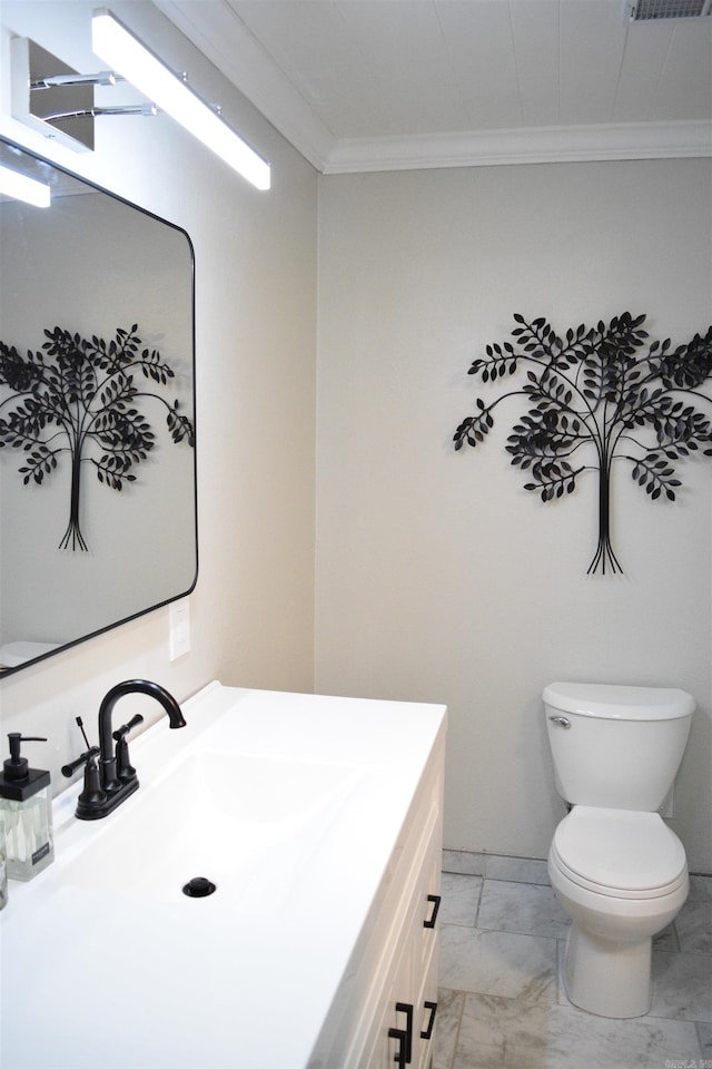 bathroom featuring crown molding, vanity, and toilet