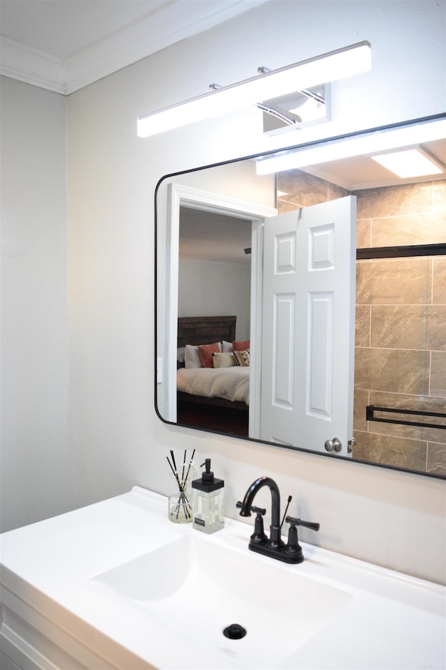 bathroom featuring ornamental molding and sink