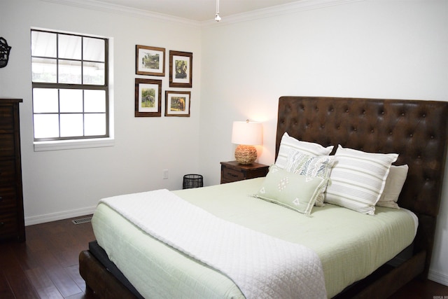 bedroom with dark hardwood / wood-style floors and crown molding