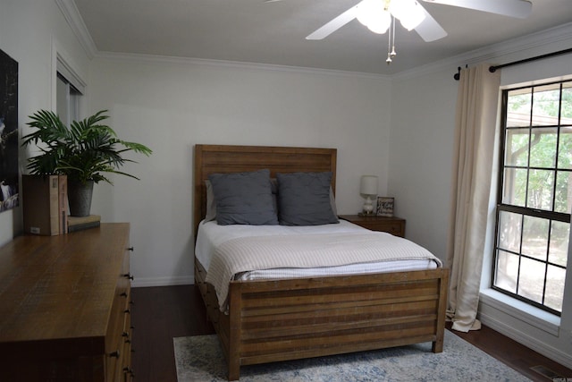 bedroom featuring ceiling fan, dark wood-type flooring, and ornamental molding