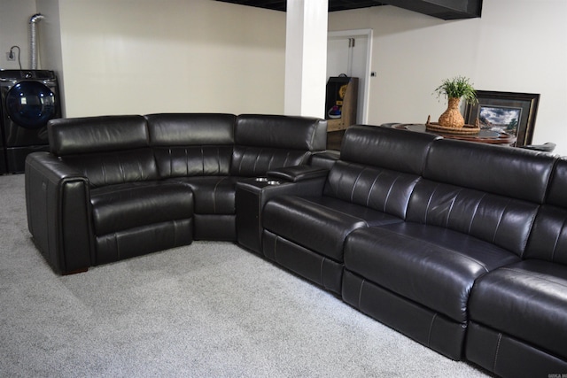 living room featuring carpet and washer / dryer