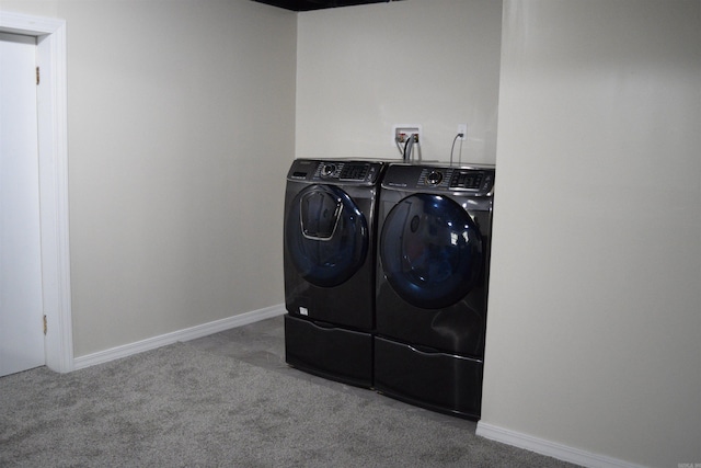 laundry area with carpet flooring and washing machine and dryer