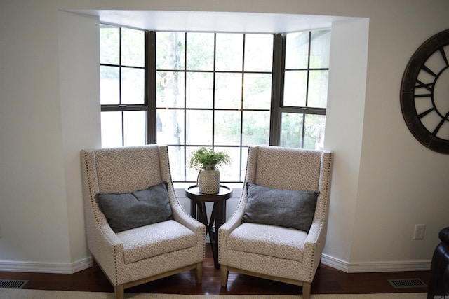 sitting room with hardwood / wood-style flooring and a healthy amount of sunlight