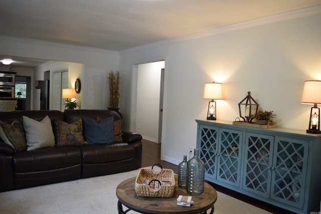 carpeted living room featuring ornamental molding