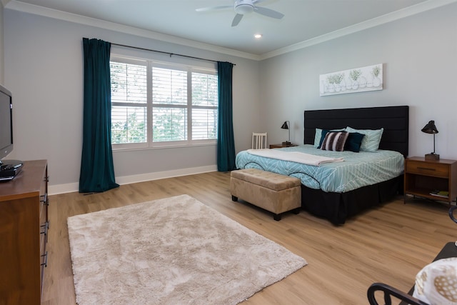 bedroom with hardwood / wood-style flooring, ceiling fan, and crown molding