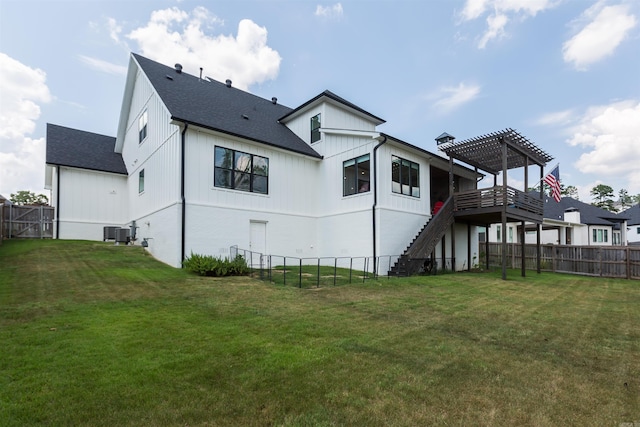 rear view of house with a pergola, a wooden deck, a yard, and central air condition unit