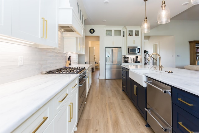 kitchen featuring white cabinets, blue cabinets, light hardwood / wood-style flooring, decorative light fixtures, and stainless steel appliances