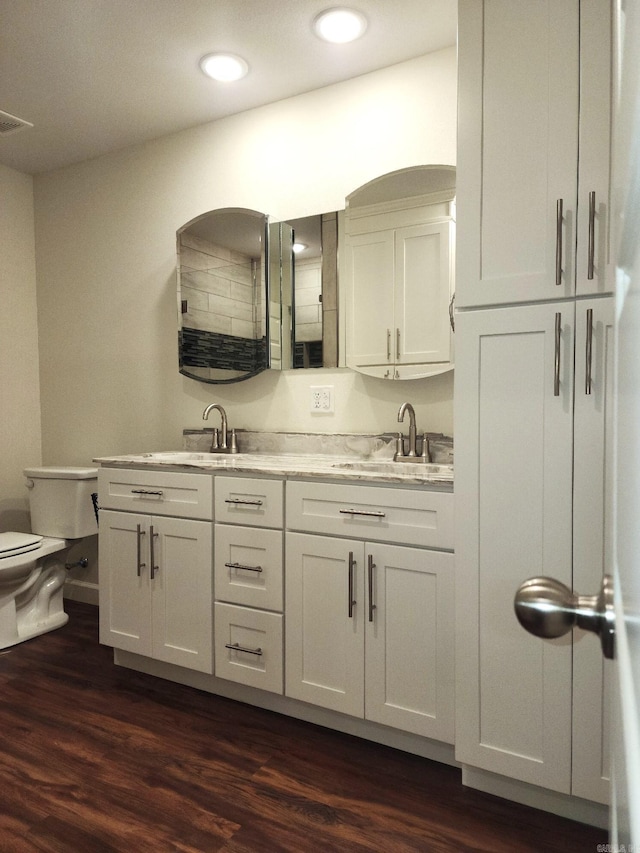 bathroom featuring hardwood / wood-style floors, vanity, and toilet