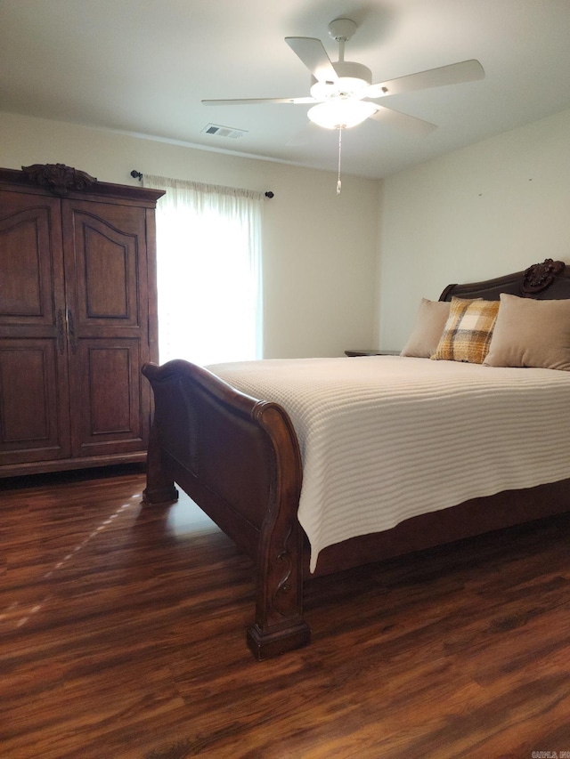 bedroom featuring ceiling fan and dark hardwood / wood-style flooring