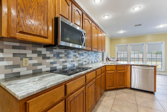 kitchen featuring light stone countertops, stainless steel appliances, crown molding, decorative backsplash, and light tile patterned floors