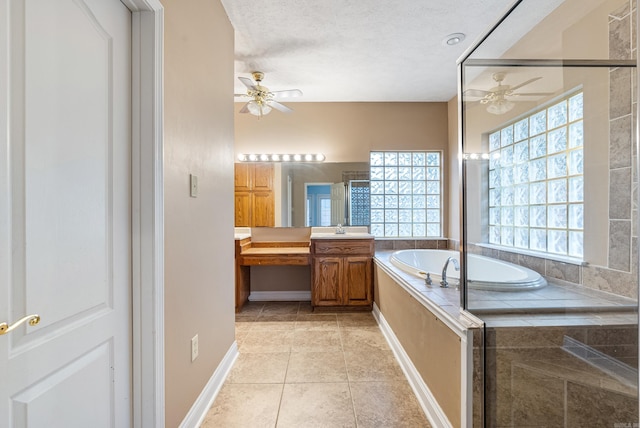 bathroom with vanity, tile patterned flooring, ceiling fan, shower with separate bathtub, and a textured ceiling