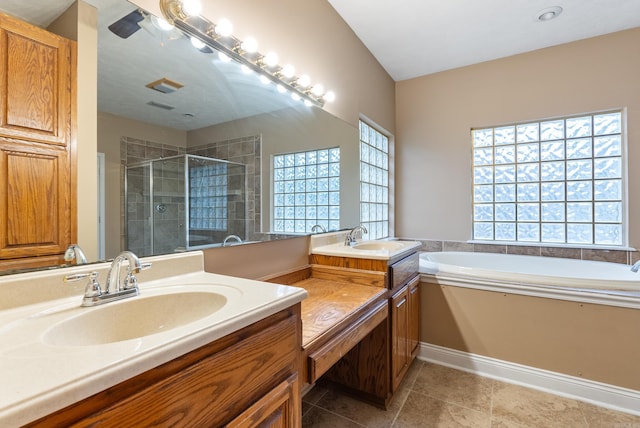 bathroom featuring plus walk in shower, vanity, and tile patterned floors