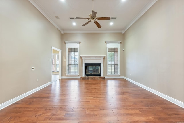 unfurnished living room with hardwood / wood-style floors, ceiling fan, and ornamental molding