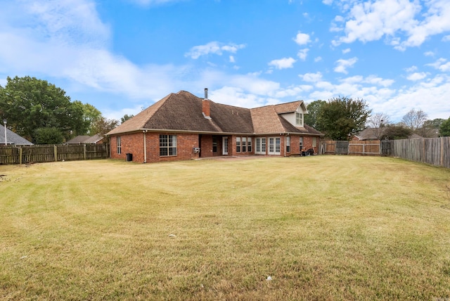 rear view of house with a lawn