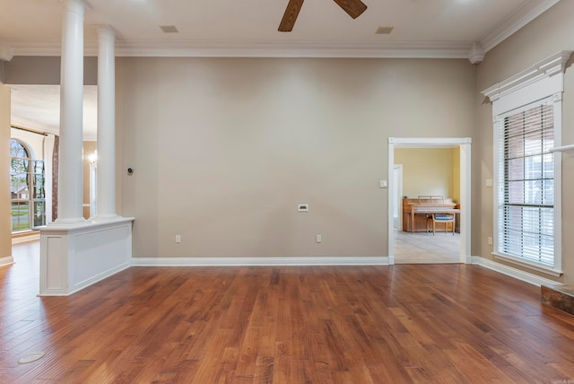 empty room with light wood-type flooring, ornate columns, and a healthy amount of sunlight