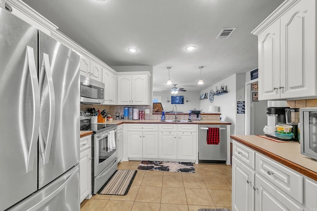 kitchen featuring backsplash, sink, white cabinets, and stainless steel appliances