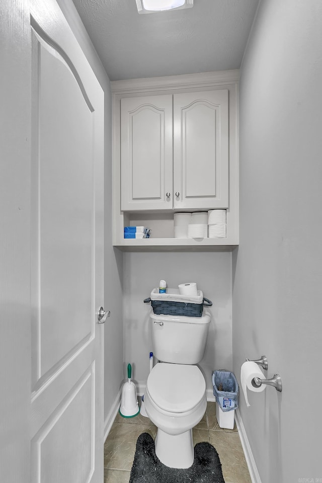 bathroom featuring toilet and tile patterned floors