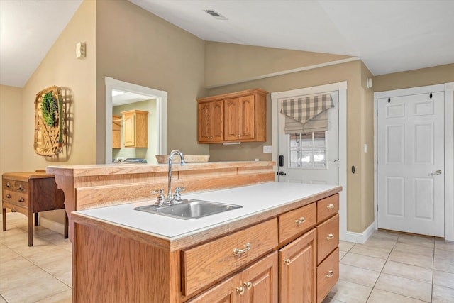 kitchen with light tile patterned floors, a kitchen island with sink, lofted ceiling, and sink