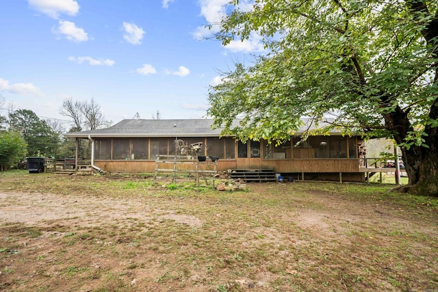 back of property with a sunroom