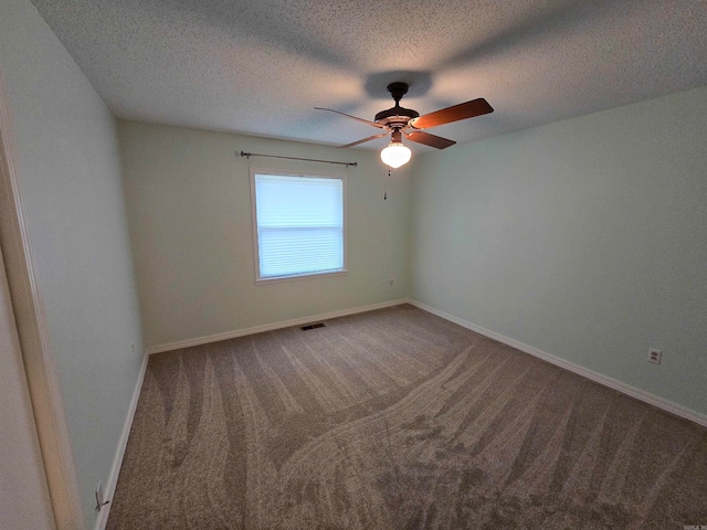 carpeted empty room featuring a textured ceiling and ceiling fan