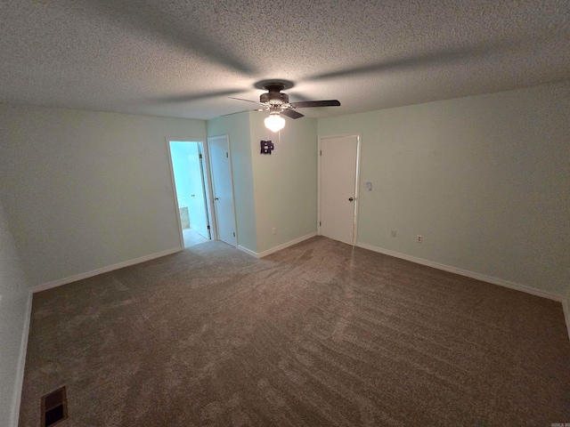 carpeted spare room with ceiling fan and a textured ceiling