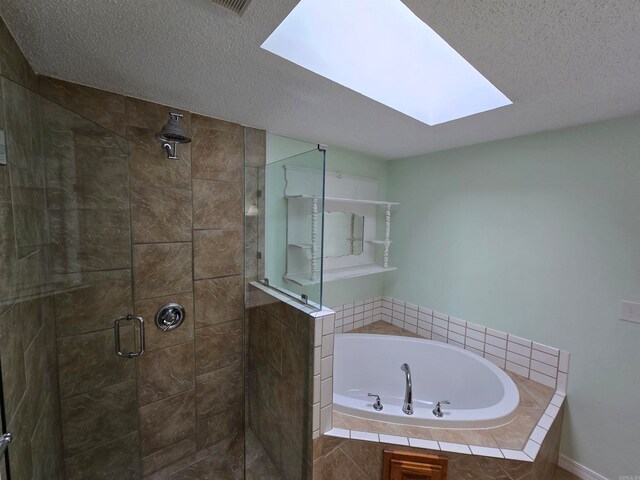 bathroom featuring a textured ceiling, independent shower and bath, and a skylight