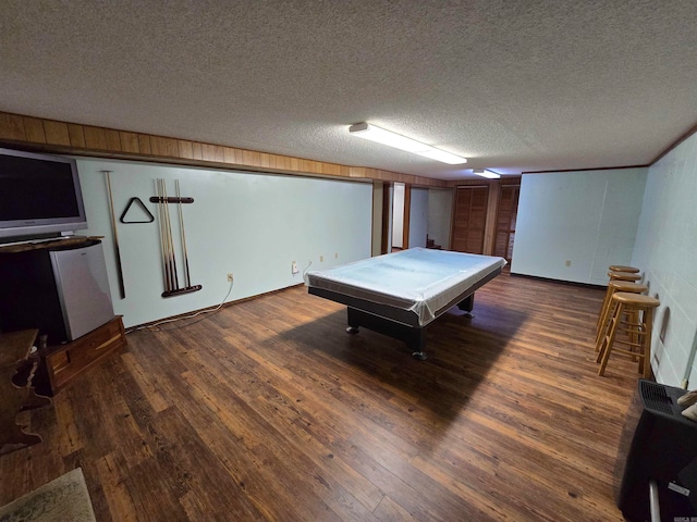 playroom with dark hardwood / wood-style flooring, a textured ceiling, and pool table