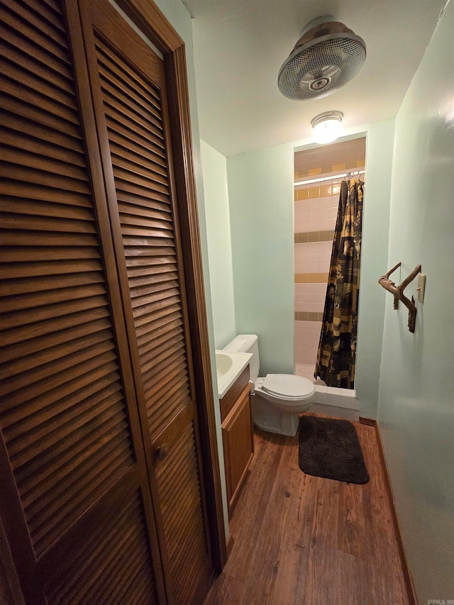 bathroom featuring toilet, vanity, wood-type flooring, and a shower with shower curtain