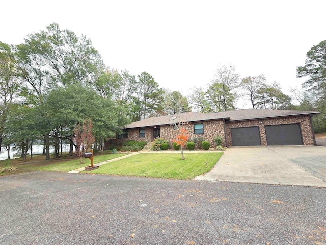 ranch-style house featuring a garage and a front lawn