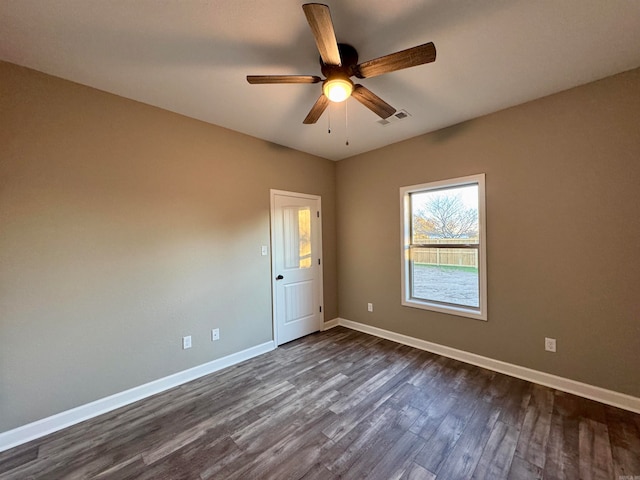 spare room featuring dark hardwood / wood-style floors and ceiling fan