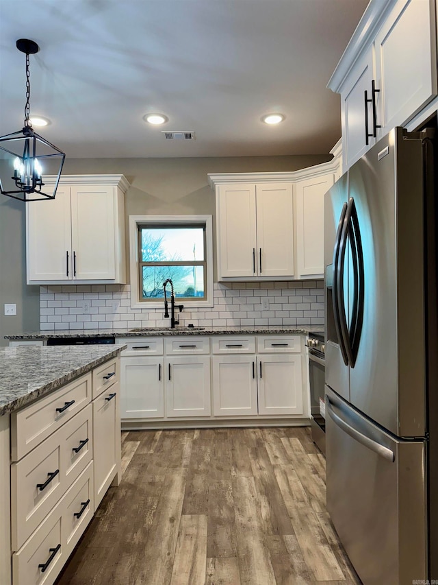 kitchen featuring white cabinetry, light wood-type flooring, and appliances with stainless steel finishes