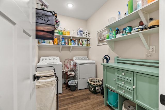 washroom with washer and dryer and dark wood-type flooring