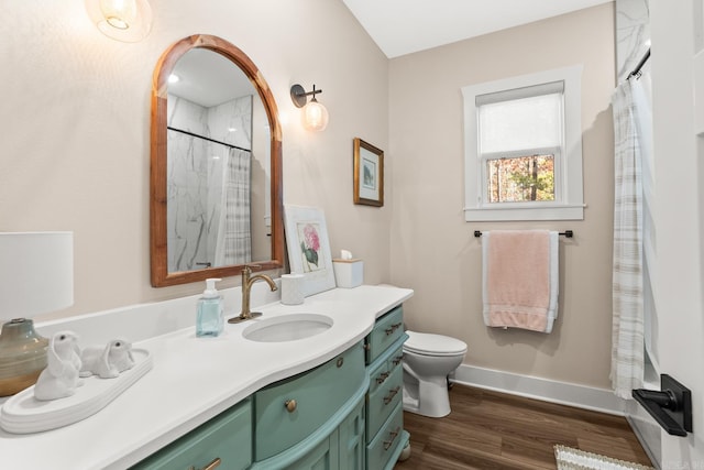 bathroom with hardwood / wood-style floors, vanity, toilet, and a shower with shower curtain