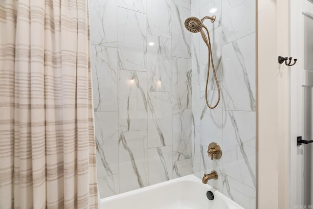 bathroom with shower / bath combo with shower curtain