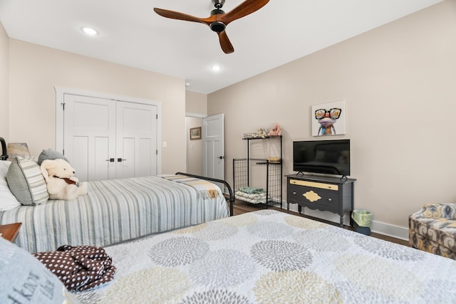 bedroom featuring ceiling fan, wood-type flooring, and a closet