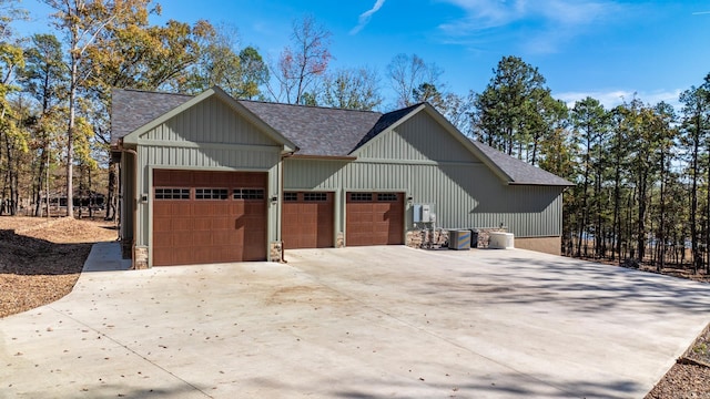 view of front of property featuring central air condition unit and a garage