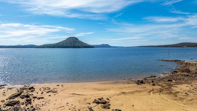 property view of water featuring a mountain view and a view of the beach