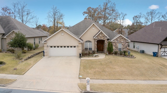 view of front of house with a garage, a front lawn, and central air condition unit