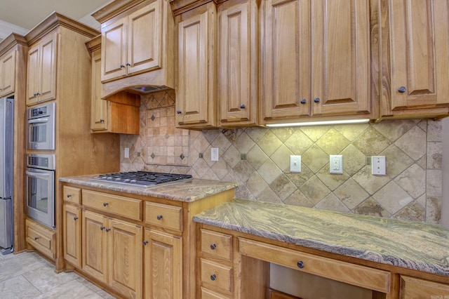 kitchen with backsplash, light stone counters, premium range hood, and stainless steel appliances