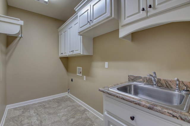 clothes washing area featuring cabinets, sink, washer hookup, light tile patterned floors, and hookup for an electric dryer