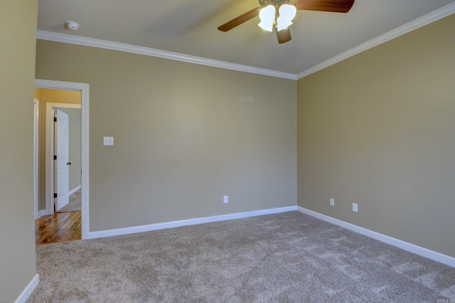 spare room featuring ceiling fan, light colored carpet, and ornamental molding