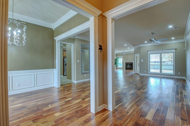 interior space featuring hardwood / wood-style floors, a chandelier, and ornamental molding