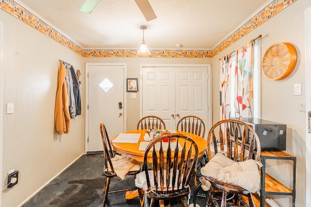 dining room with ceiling fan and a textured ceiling