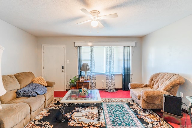 living room with carpet flooring, ceiling fan, and a textured ceiling