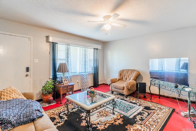 living room featuring ceiling fan and a textured ceiling