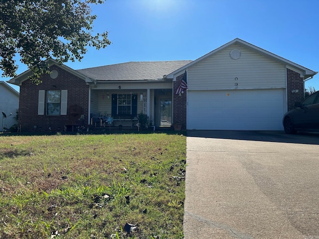 single story home with a porch, a garage, and a front yard