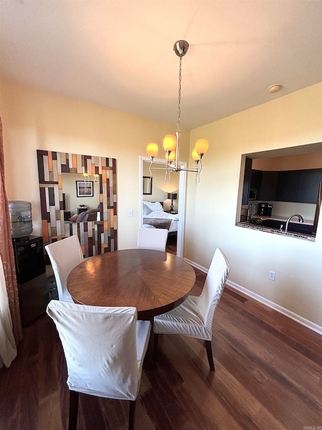 dining room with a chandelier and dark wood-type flooring