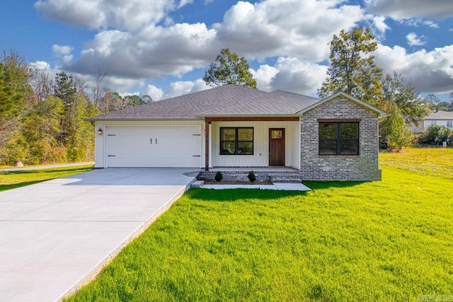 view of front of property featuring a garage and a front lawn