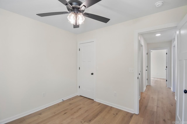 empty room featuring ceiling fan and light hardwood / wood-style flooring